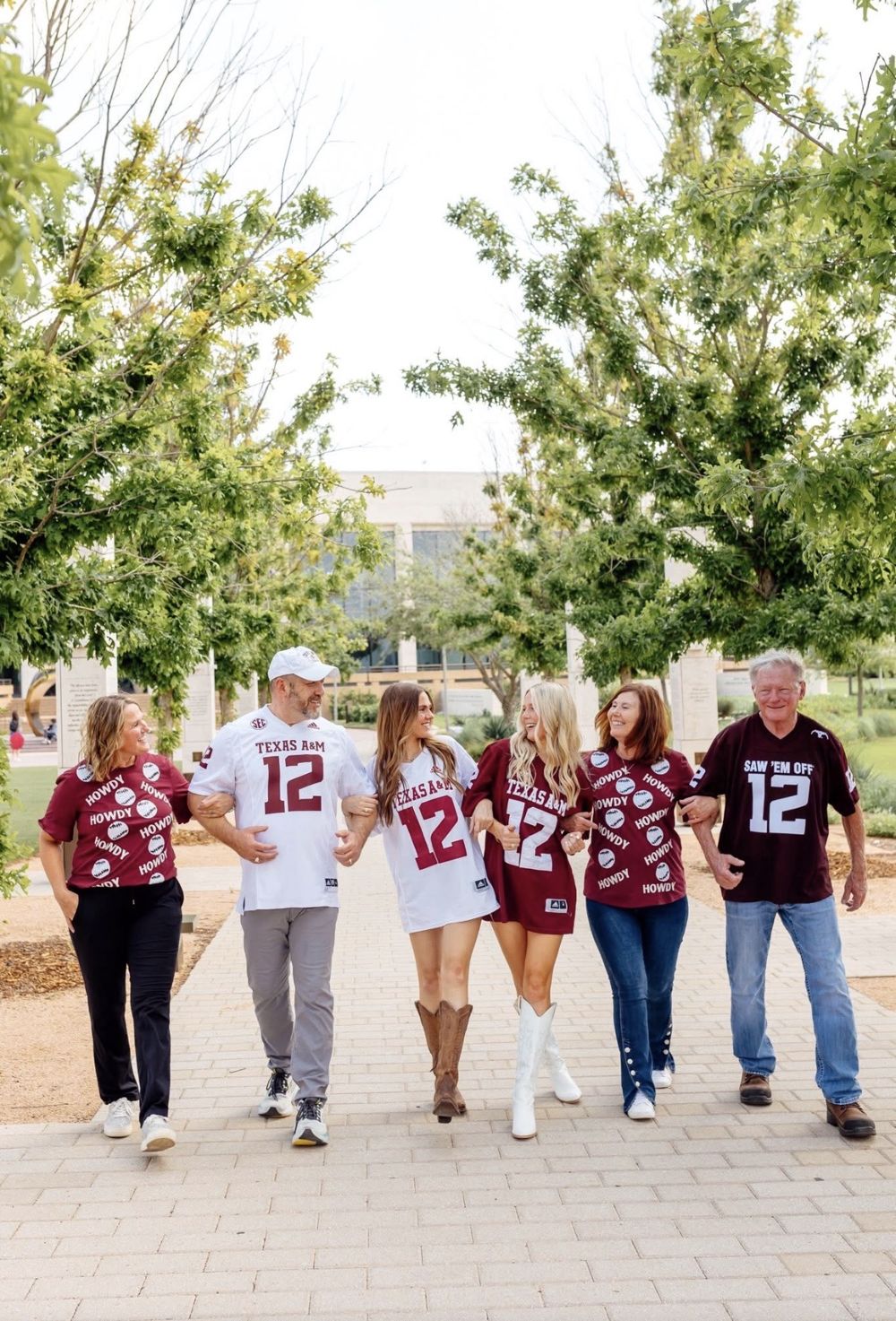 The Howes family walking together arm in arm